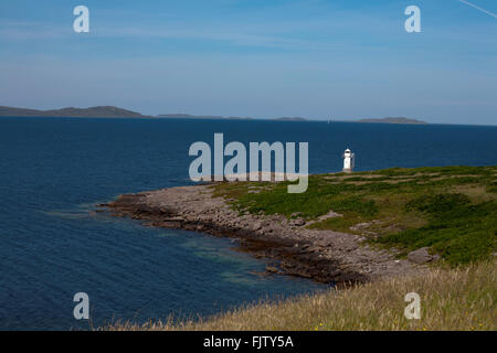 The lighthouse at Rubha Cadail on the northern shore of the entranceto Loch Broom Ullapool Wester Ross Scotland Stock Photo