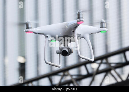 Tokyo, Japan. 3rd March, 2016. The new generation Phantom 4 that can dodge obstacles and track performs during a media event in Roppongi Hills on March 3, 2016, Tokyo, Japan. DJI's new model integrates a set of stereo cameras and proximity sensors that work with a computer software vision, which allows the Phantom 4 to fly autonomously. The new generation drone includes two newly added features, the ActiveTrack to continuously record a moving object and TapFly that allows users to select waypoints by controlling their smartphone or tablet. Credit:  Aflo Co. Ltd./Alamy Live News Stock Photo