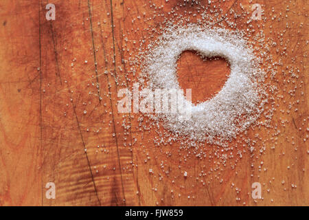 Heart-shaped sugar on cutting board Stock Photo