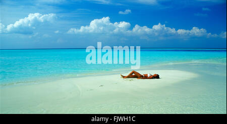 Panoramic shot of woman resting on sandbar during holidays in your favorite island paradise Stock Photo