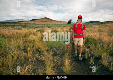 ID00507-00...IDAHO - Hiker on the Wilderness Trail in Craters of the Moon National Monument and Preserve. Stock Photo