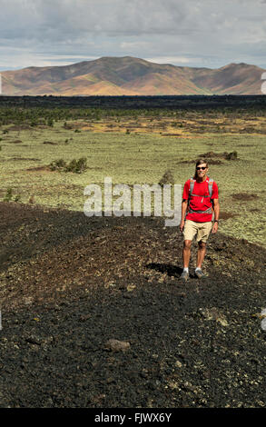 ID00510-00...IDAHO - Hiker climbing The Sentinel on the Wilderness Trail in Craters of the Moon National Monument and Preserve. Stock Photo