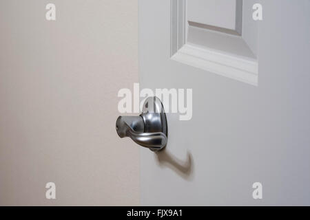 Silver colored lever style door handle on interior door. Stock Photo