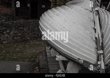 old worn-out vintage life boat, close-up of the peeling paint, as it sits abandoned in dry dock. Stock Photo