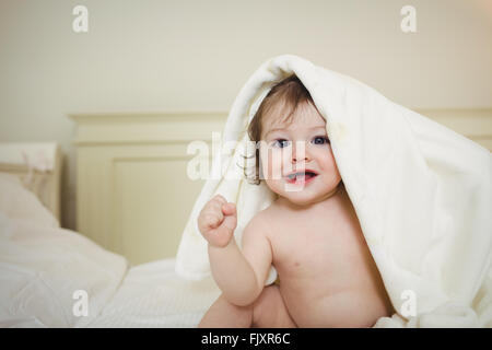 Cute baby hiding under a blanket Stock Photo