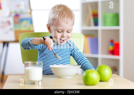kid eating healthy food at home or kindergarten Stock Photo