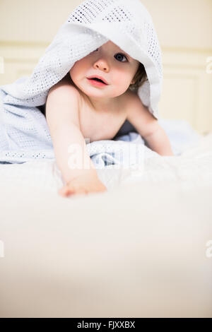 Cute baby hiding under a blanket Stock Photo