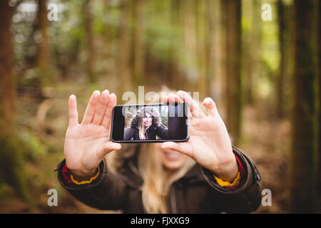 Beautiful blonde woman taking selfie Stock Photo