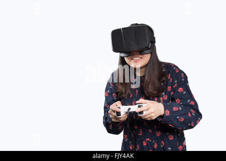 Asian girl playing game with VR glasses