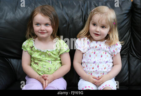 two little two year old girls children kids, sitting together, togetherness concept, innocent concept, childhood friends besties best friends friend Stock Photo