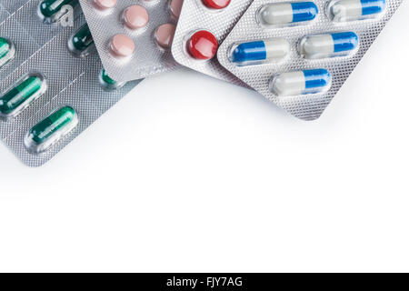 Pills and capsules in aluminum container on white background Stock Photo