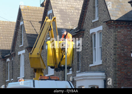 Workman replacing a lamp post light in a cherry picker boom lift in ...