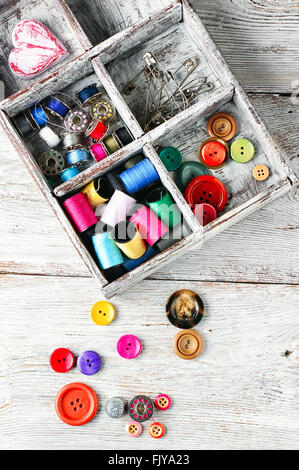 Light wood box with threads,buttons and pins.Top view Stock Photo