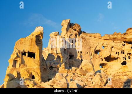 Part of cliff dwelling complex of ancient Christian churches and houses in village of Cavusin near Goreme, Cappadocia, Turkey Stock Photo