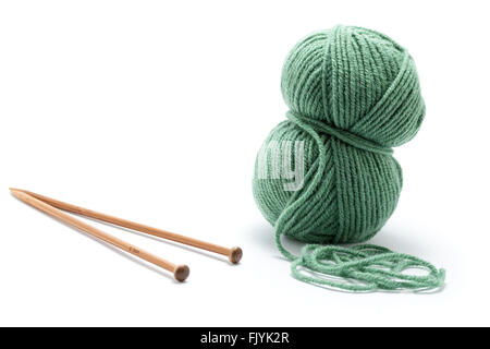 Skein of green yarn with knitting needles Stock Photo