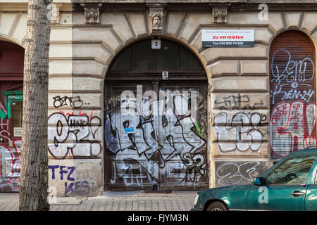 Rental properties in Berlin. Arches, graffiti tags on the walls of a building. Stock Photo