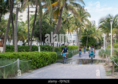 People on bicycles on South Beach Boardwalk in Miami Beach, Florida, USA Stock Photo