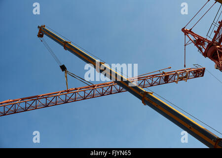 Construction worker dismantling tower crane Stock Photo