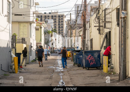 Street scene with local people, cars and waste containers in Collins Court in South Beach district of Miami Beach, Florida, USA Stock Photo