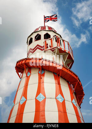 Vintage Helter Skelter fairground ride in summer with union flag, painted orange and cream Stock Photo