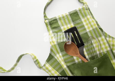 Cooking background. Flat kitchen accessories. Apron and silicone cooking  utensil with wooden handle on beige background with copy space. Top view  Flat Stock Photo - Alamy