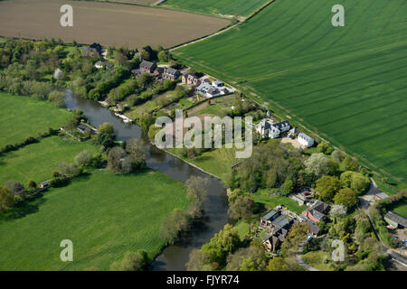 An aerial view of some large houses near a river in the English countryside Stock Photo