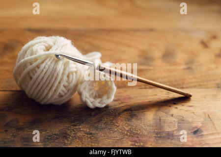 Crochet hook on wooden background Stock Photo