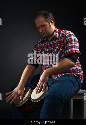 portrait of musician with bongo , studio shot Stock Photo