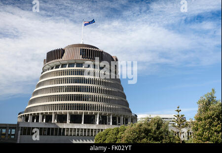 The Beehive, Parliament Buildings with the New Zealand flag fluttering on the building, Wellington, New Zealand Stock Photo