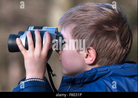 Boy looking through binoculars, Bavaria, Germany Stock Photo