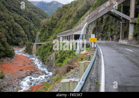 Rockslide shelter and water bridge over New Zealand State Highway 73 Stock Photo