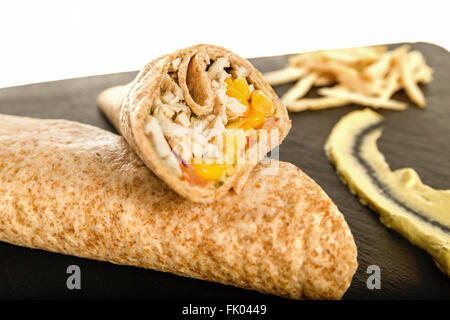 Sandwich Wrap or Tortilla with Leftover Meat, Cheese Pork and Corn on Black Chopping Board Over White. Tasty Fast Food, Mexican  Stock Photo