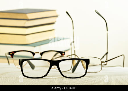 reading glasses and books on the white table Stock Photo
