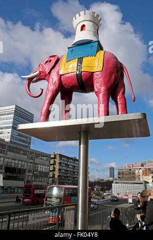 The Elephant & Castle statue and buses in traffic at the roundabout ...