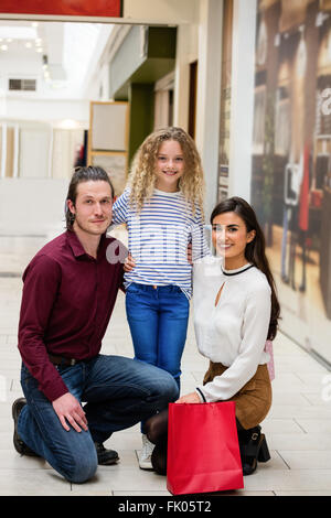 Portrait of happy family in shopping mall Stock Photo