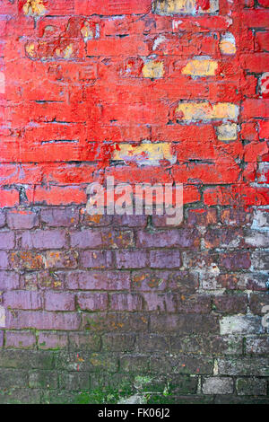 Grungy brick wall painted in pink and violet colors Stock Photo