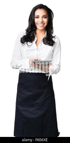 Hispanic waitress in her twenties taking order on digital tablet computer isolated on white background Stock Photo