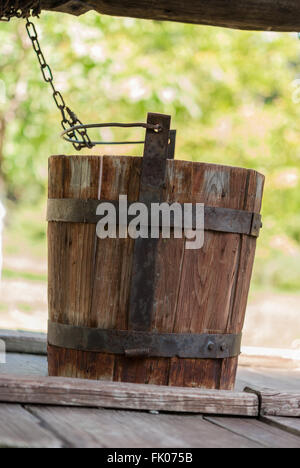 Detail of the draw-well with the old wooden bucket closeup. Dimitrie Gusti National Village Museum. Bucharest. Romania. Stock Photo