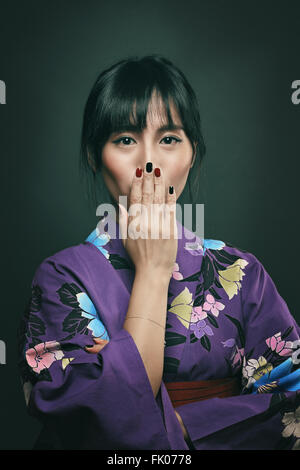 Beautiful japanese woman with funny and surprise expression. Studio light Stock Photo