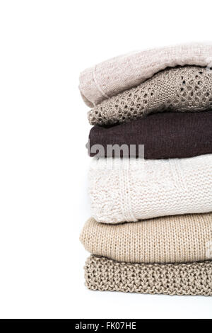stack of brown woolen knitted sweaters isolated on white background Stock Photo