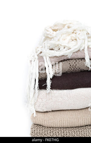 stack of brown woolen knitted sweaters isolated on white background Stock Photo