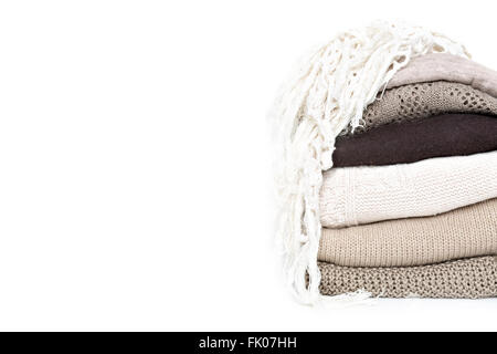 stack of brown woolen knitted sweaters isolated on white background, copy space Stock Photo