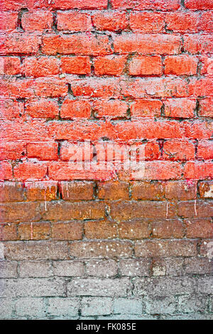 Old Bricks wall Painted in orange color, half weathered Stock Photo