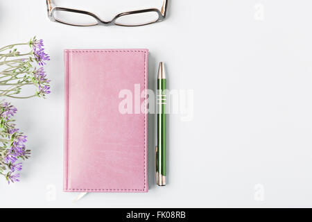 closed notebook with pen on blue table, flat lay Stock Photo