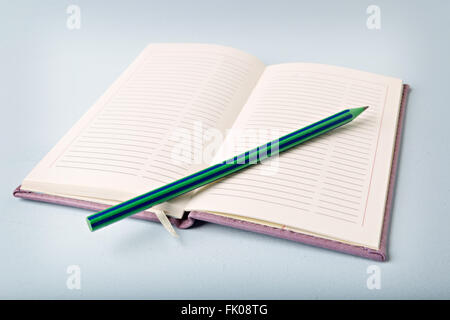 opened notebook on blue table, flat lay Stock Photo