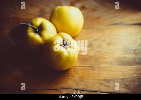 Organic ripe quince on wooden table Stock Photo