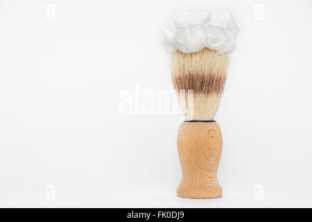 Wooden classic shaving brush with foam isolated on white background with copy space on the left side Stock Photo