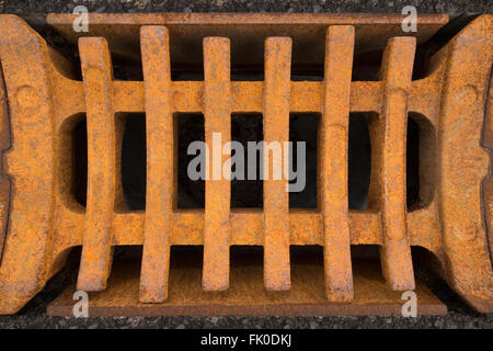 Rusty square grid of a storm drain in close-up Stock Photo