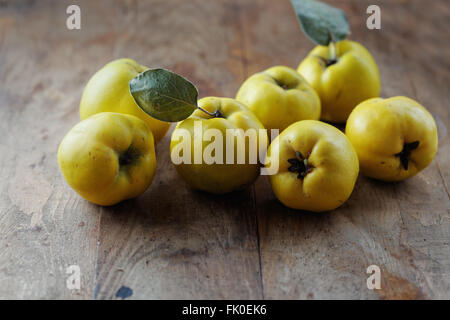 Organic ripe quince on wooden table Stock Photo