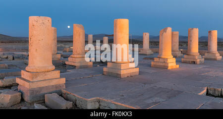 Columns of palace audience hall and rising moon at Pasargardae, the site of the tomb of Cyrus the Great. Archaemenid era. Iran Stock Photo